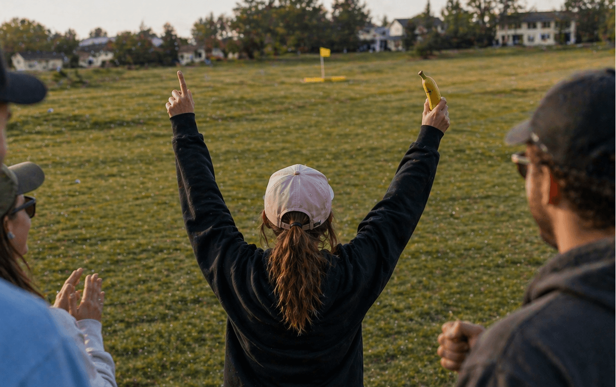 Group celebrating a hole-in-one golf challenge in Raleigh North Carolina with player holding a banana after winning cash prize